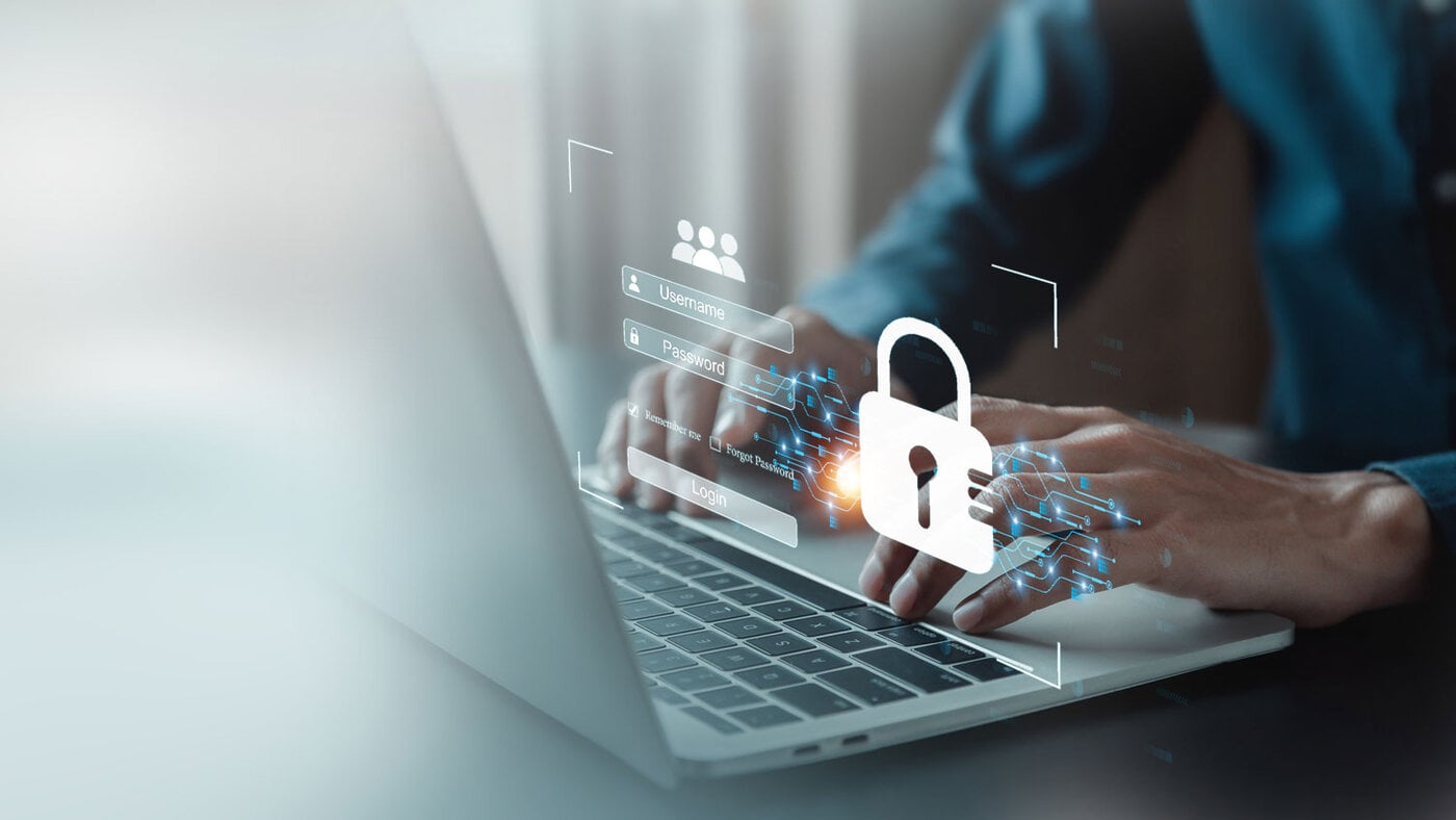 Laptop mit Login-Grafik und Schloss-Symbol als Symbol für Cybersicherheit.