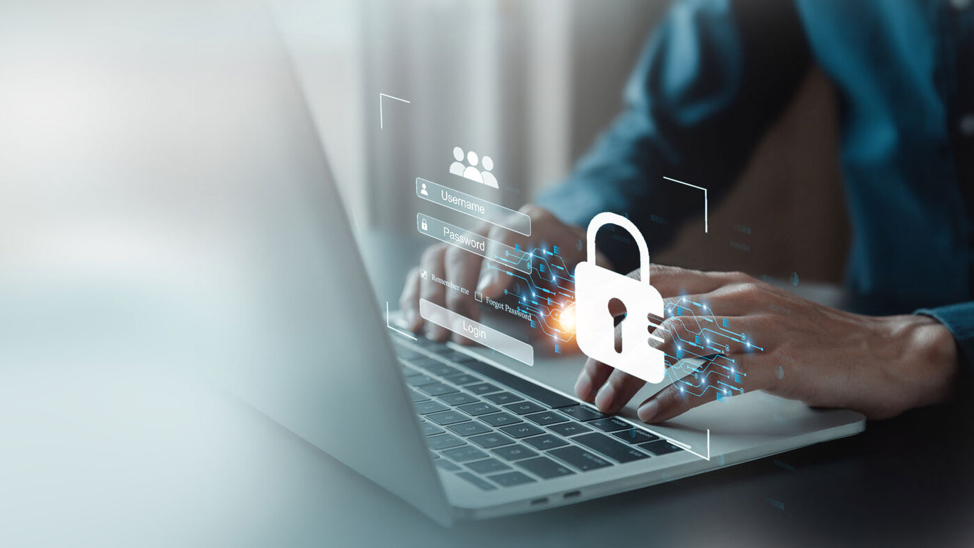 Laptop mit Login-Grafik und Schloss-Symbol als Symbol für Cybersicherheit.